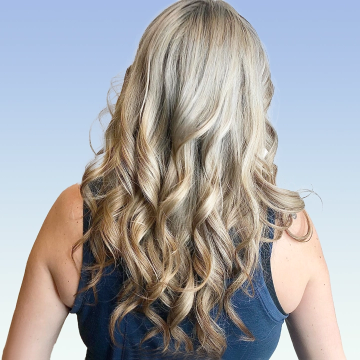A picture of hair styled with a perm, showing soft curls and volume