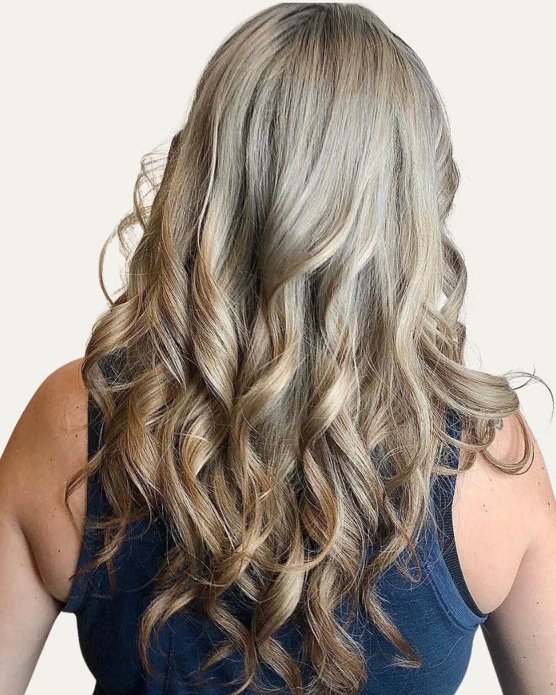 A picture of hair styled with a perm, showing soft curls and volume